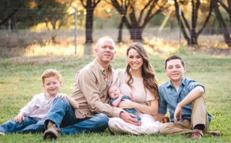 courtes y photo Dale Wayne and his wife, Kalyn, hold their baby Dale Jr. as they sit alongside their older sons Grayson, at left, and Brodie.