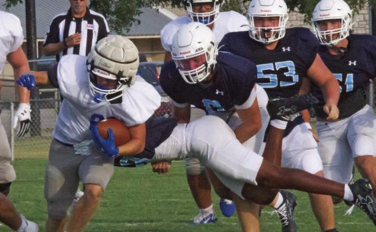 The Badgers look for an open lane on a rushing play against the Liberty Hlll Legacy Ranch Wranglers last Friday in the season’s first scrimmage. JEFF LOWE | COURTESY PHOTO