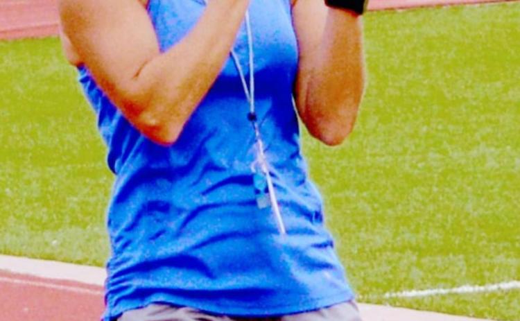 Christy Wiley cheers on athletes during Speed, Weights and Agility Training on Wednesday. JEFF LOWE | DISPATCH RECORD