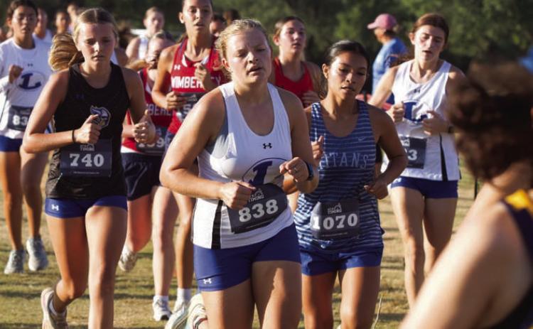 The Lampasas cross country team participated in a large meet Friday in Cedar Park. Sophia Storm, in foreground, is followed closely by her teammates as the varsity girls headed toward the finish line. ERICK MITCHELL | DISPATCH RECORD