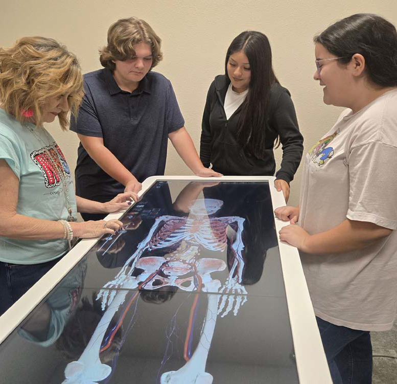 CHERI JAY-WIENECKE | DISPATCH RECORD Lometa medical teacher Valarie Nixon works with students on the Anatomage Table the district purchased with funds from a Texas Workforce Jobs and Education for Texans Grant. Pictured are, from left to right, Nixon, Tepekos Bowers, Amy Padron and Sophie Anguiano.