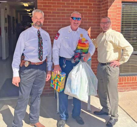 From left to right: Lampasas Police Department Chief Jody Cummings, Lampasas Fire Department Chief Jeff Smith and Lampasas City Manager Finley deGraffenried pose for a photo during the Dec. 4 luncheon event to raise funds for the Lampasas Volunteer Fire Department’s toy drive. courtesy photo | Lampasas Fire Department