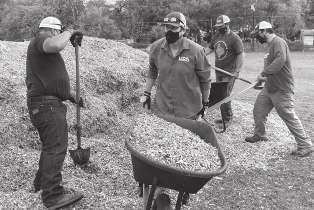Lower Colorado River Authority employees spread mulch at W.M. Brook Park on Friday during LCRA’s Steps Forward Day. COURTESY PHOTO