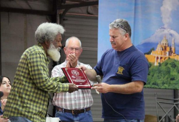At last year’s barbecue and auction, Kempner Volunteer Fire Department Chief Dan Hause, right, presented an award to Otho King for many years of assisting with the fundraiser. FILE PHOTO