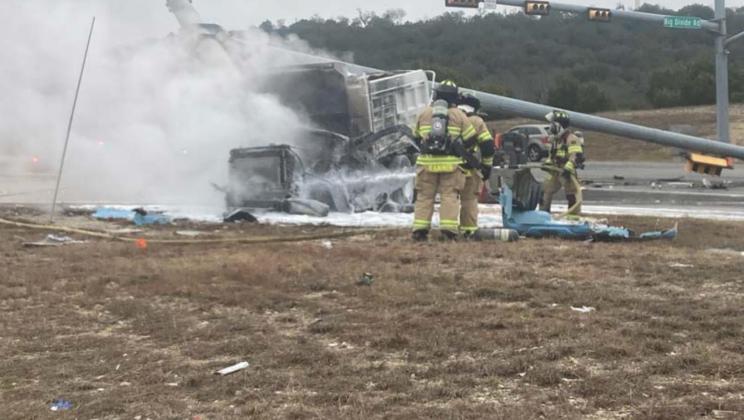 Copperas Cove firefighters extinguish flames from a gravel truck involved in a two-vehicle collision Tuesday morning near Big Divide Road. MONIQUE BRAND | DISPATCH RECORD