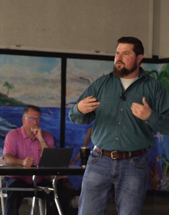 ERICK MITCHELL | DISPATCH RECORD Public Works Director Stephen Sewell, standing, presided over a town hall session last week to offer residents an update on city water conditions. Seated at back is Van Sims, the city’s water/wastewater plant operations manager.