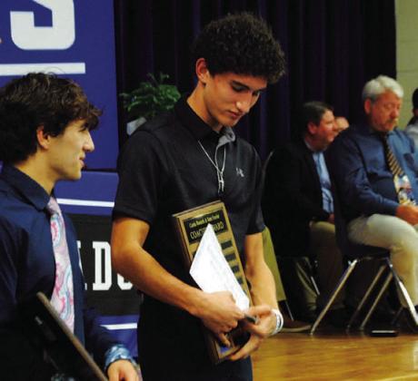 Ayden Shaw holds onto his Coaches’ Award for the 2022 season. HUNTER KING | DISPATCH RECORD