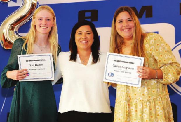 Kali Hunter, left, and Caitlyn Sanguinet, right, smile with their head coach at the banquet. CHRIS MILES | COURTESY PHOTO