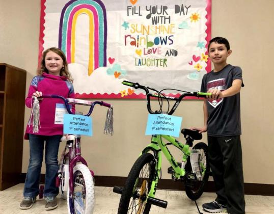 Second-grade student Emerson Evans, left, and fourth-grade student Nolan Clary had their names selected to receive a bicycle from among those students who earned perfect attendance recognition for the first semester of the 2020-2021 school year. COURTESY PHOTO
