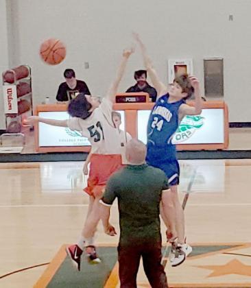 Calum Mitchell (24) goes for the opening tipoff in the seventh-grade “A” boys’ game. COURTESY PHOTO
