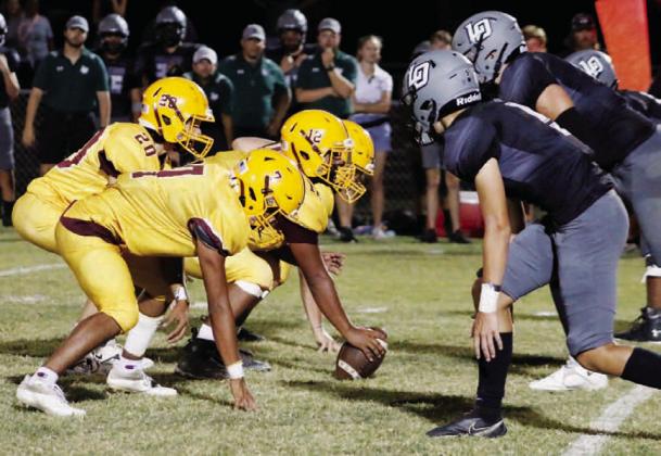 MASON HINES | DISPATCH RECORD The Hornets line up against Waco Live Oak during last week’s game. Lucas Smailus Cruz (22) runs the ball during Lometa’s loss Friday.
