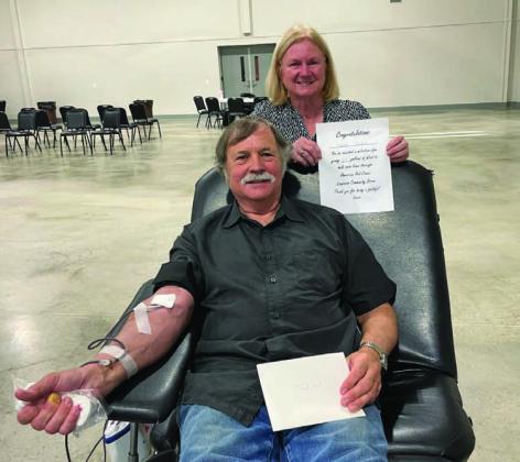 Clark Corbin is pictured making a blood donation, assisted by volunteer Janet Machen, at last week’s American Red Cross community drive. With his recent donation, Corbin has recorded a 23-gallon milestone to help save others in need of blood. COURTESY PHOTO