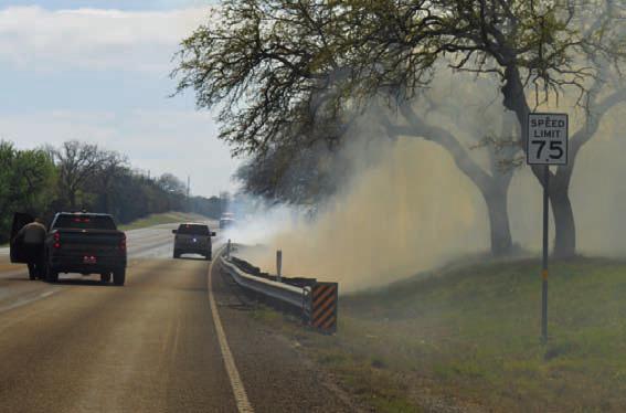 A grass fire along U.S. Highway 281 South past the entrance to Lampasas High School sent smoke across the roadway Wednesday afternoon, and area fire crews had to be called in to assist the Lampasas Fire Department in putting out the blaze. ERICK MITCHELL | DISPATCH RECORD