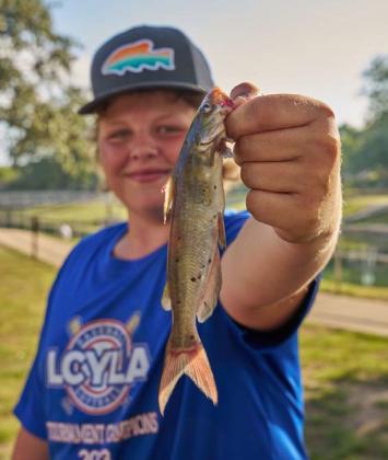 The first catch of the day was a 3/8-inch catfish by Tucker Romine in the 12- to 16-year-old division. ADAM BARRIOS | DISPATCH RECORD