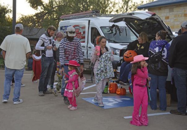 Area children and parents make their way through the different stops of Tuesday night’s Trunk or Treat event at Kempner City Hall, where costumes and sweet treats were in abundance. ERICK MITCHELL | DISPATCH RECORD