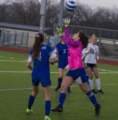 Goalkeeper Keona Cartwright makes a save in the Lady Badgers’ home match against Gatesville, while Nyla Long (4) assists on defense. JEFF LOWE | DISPATCH RECORD
