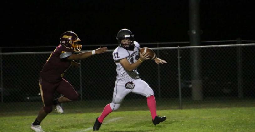 Elijah Golzales chases down the Zephyr quarterback during the Hornets’ dominant win last Friday. MEGAN LUSTY | DISPATCH RECORD
