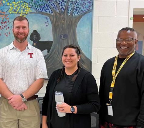 Clay Phillips of Texas Farm Bureau Insurance, at left, presented Emily Baum with tokens of appreciation to recognize her designation as Paraprofessional of the Month at Taylor Creek Elementary. They are joined by Assistant Princpal Mark Sheppard. courtesy photo