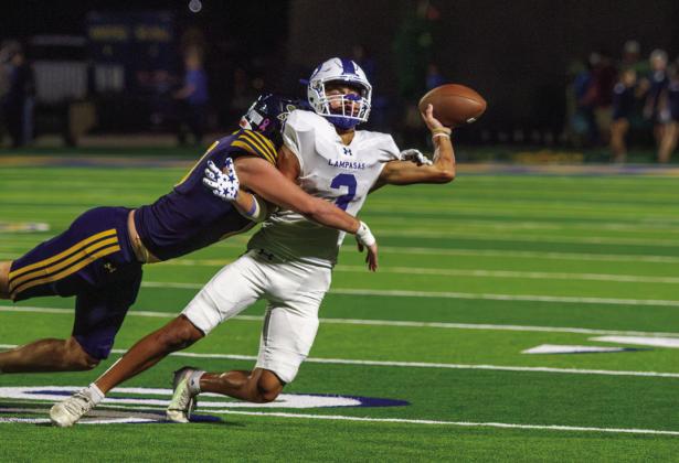 Lampasas senior receiver Tripp Stinnett attempts a double pass play before he is tackled by Stephenville’s defense. PHOTO BY ANA SOFIA MEYER