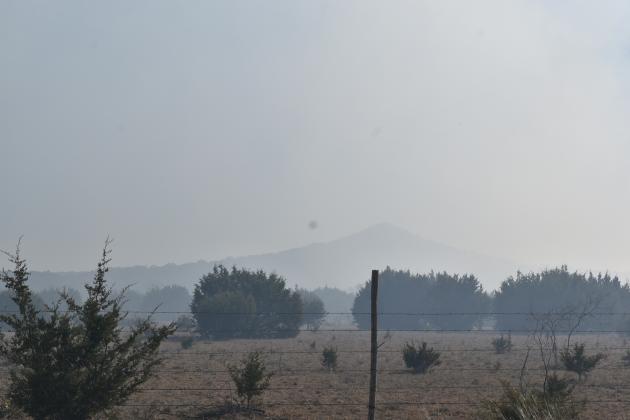Smoke obscures a high peak north of Lampasas near CR 2234. Photo by Madeleine Miller