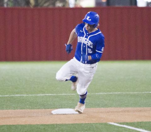 Ace Whitehead rounds second base on a triple. He scored on this play after a Glen Rose error on the throw to third base. 