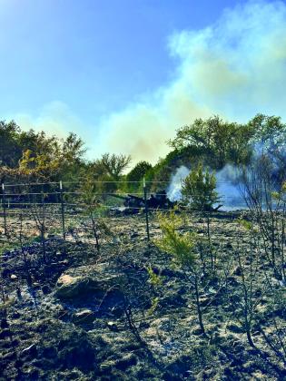 JOYCESARAH MCCABE | DISPATCH RECORD Smoke rises from a charred section of ground during the Lucy Creek fire on Sunday afternoon. 