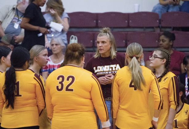 Coach Madison Morris gives a pep talk to her team. The Lady Hornets are looking for their first district win. ANA SOFIA MEYER | DISPATCH RECORD