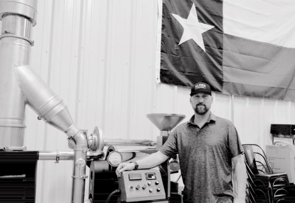 Alamo Coffee Company owner Aaron Cornish stands by a roasting machine in Alamo’s Lampasas warehouse. The machine will move to Alamo’s café so customers can observe the roasting process. MADELEINE MILLER | DISPATCH RECORD