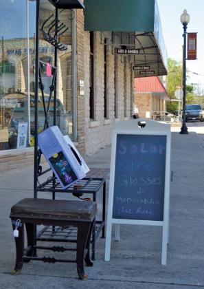 A sign outside The Trading Post on the downtown square advertises the sale of solar eclipse glasses. Many businesses and local residents are gearing up for the solar eclipse on April 8. Erick Mitchell | dispatch record