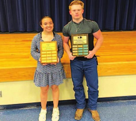 Brianna Miller, left, and Westen Reid pose with their Battlin’ Badger trophies at the powerlifting banquet. COURTESY PHOTO