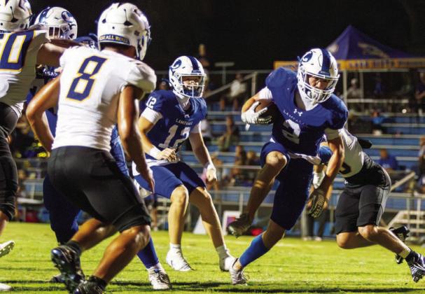 Lampasas senior Jonathan Bowling, a two-way player at defensive back and running back, breaks a tackle to sneak into the end zone for his second touchdown of the night against Lago Vista. ANA SOFIA MEYER | DISPATCH RECORD