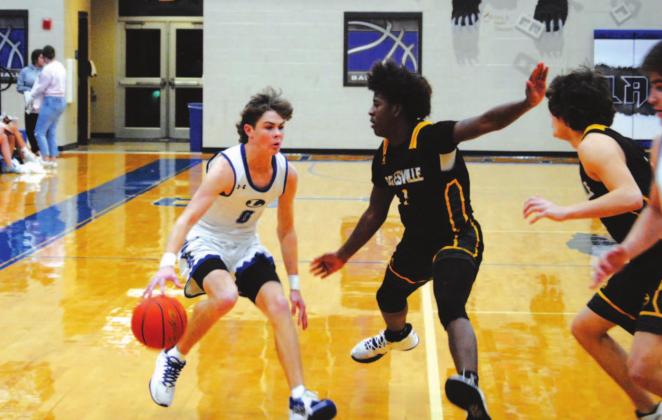 Nate Borchardt dribbles and looks for a way past two Gatesville defenders in a game last week. HUNTER KING | DISPATCH RECORD