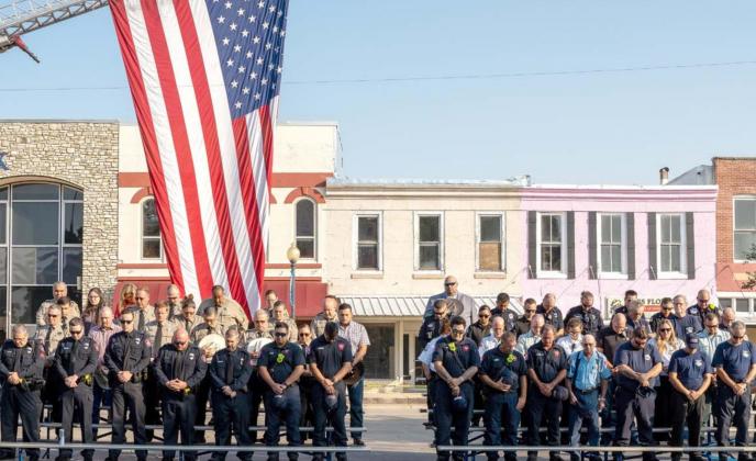 Lampasas County first responders bow their heads during the invocation at the county’s 9/11 remembrance ceremony held at the courthouse square Saturday morning. An estimated 200 people attended the ceremony. JEROMIAH LIZAMA | DISPATCH RECORD