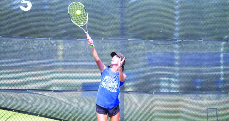 Chesley Breuer makes contact on a serve during a match last week. HUNTER KING | DISPATCH RECORD