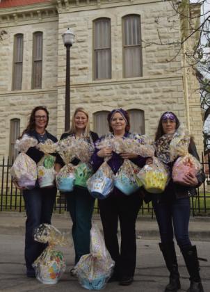 Shown left to right: Lampasas CPS Board President Colleen Eckermann and Board Treasurer Crystal Banks receive Easter egg baskets from Silverbacks Motorcycle Club members Diane Trujillo and Angelicca Conner. The baskets will go to children in CPS care. ERICK MITCHELL | DISPATCH RECORD