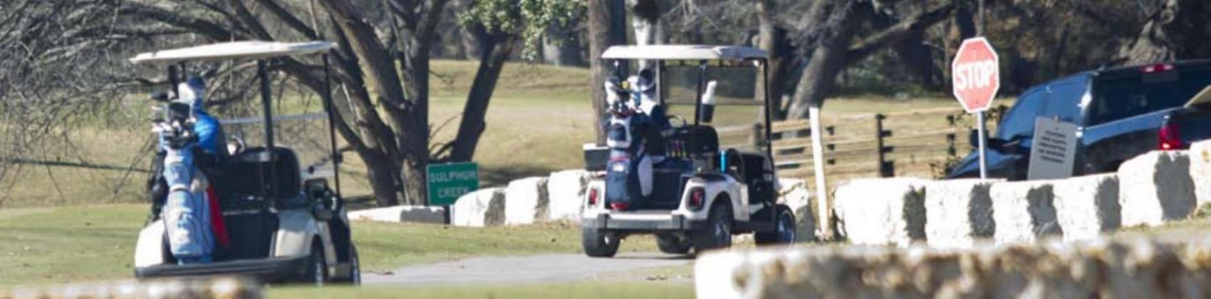 Golf cart drivers at Hancock Park Golf Course prepare to cross Naruna Road. A city ordinance stipulates that licensed drivers may operate golf carts on public roadways only to travel to and from cemeteries and the golf course. JEFF LOWE | DISPATCH RECORD