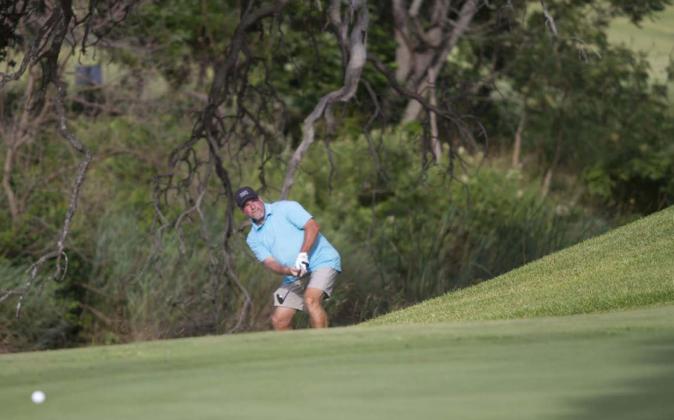 Scott Haverly hits a chip shot onto the green on his way to a third place finish in the Championship Flight of the Britches and Bows tournament on Saturday and Sunday at Hancock Park Golf Course in Lampasas. HUNTER KING | DISPATCH RECORD
