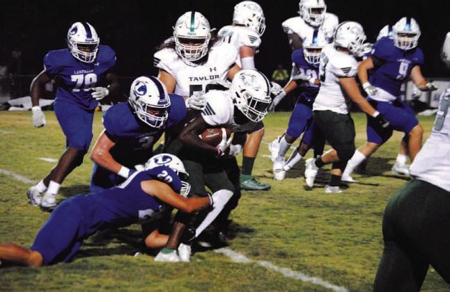 Levi Rivera (20) and Reed Jerome (3) are in on a tackle for loss during last Friday’s game. HUNTER KING | DISPATCH RECORD