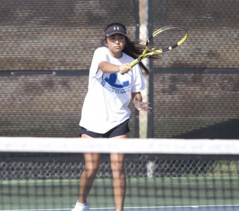 Junior Amore Zapata follows through on a forehand return during a doubles match against Leander last week. She and Alyssa Sharkey won their most recent match in straight sets. HUNTER KING | DISPATCH RECORD