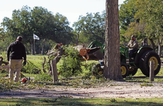Hancock Park Golf Association members offered assistance Tuesday morning to clear debris from the golf course after high winds Monday night damaged trees and left the municipal course unplayable temporarily. JOYCESARAH MCCABE | DISPATCH RECORD
