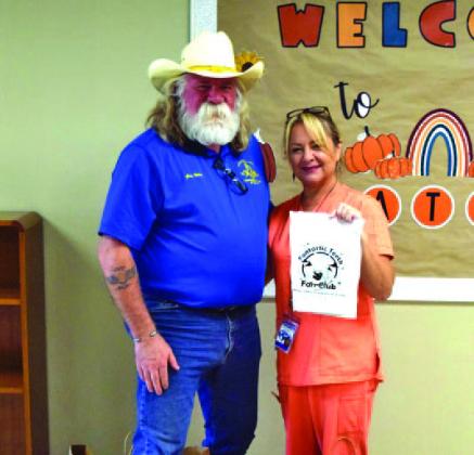 Lodge Master Guy Niles is pictured with Kline Whitis Elementary School nurse Dana Tatum, who displays one of the “Fantastic Teeth” dental kits Saratoga Lodge provided to the campus. COURTESY PHOTO