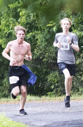 Ben Stone, left, stays in a close race with Nicolas Murphy of Cedar Park. Stone -- the Lampasas High School cross country Battlin’ Badger this year -- won the Boys’ 12-15 division of the 5K as part of Spring Ho weekend. JEFF LOWE | DISPATCH RECORD