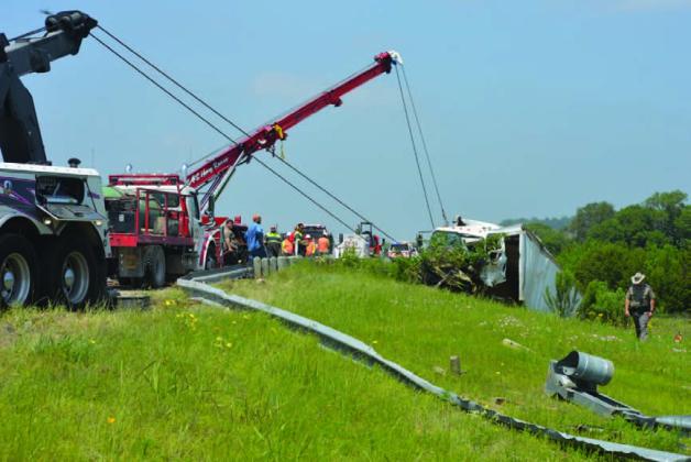 Two SAS Towing and Recovery trucks work to lift a box truck from the railroad track about 3 miles north of Lometa after a one-vehicle crash on U.S. Highway 183 North Thursday afternoon. ERICK MITCHELL | DISPATCH RECORD