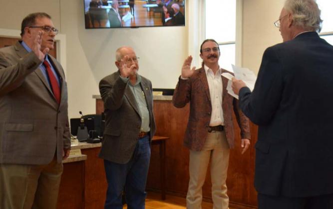 Taking the oath of office in May for Lampasas City Council are, from left, Herb Pearce and Randy Clark, who were unopposed in the municipal election this year, and Zac Morris, who beat out Clayton Tucker for the Place 1 seat. Administering the oath is Municipal Court Judge Robert Gradel. file photo