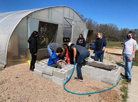 Lampasas High School students work outside the greenhouse at the campus. COURTESY PHOTO