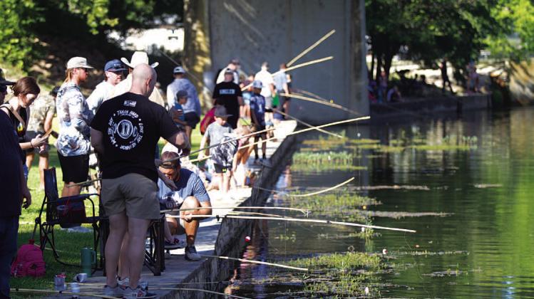 Poles lined the creek in W.M. Brook Park for the fishing derby. HUNTER KING | DISPATCH RECORD