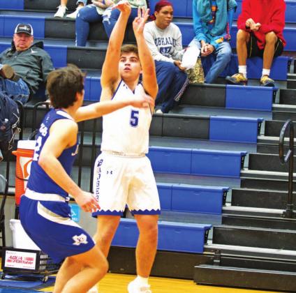 Dax Brookreson rises up over a Jarrell defender to make a three-point shot in Tuesday’s game. HUNTER KING | DISPATCH RECORD