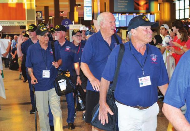 Veterans who participated in an Honor Flight to Washington, D.C. last week were greeted Saturday night by a large crowd at Austin’s Bergstrom International Airport upon their arrival back from the nation’s capital. Lampasas resident James Welch, left side of photograph holding a carry-on bag, served with the Marines during the Korean War. JIM LOWE | DISPATCH RECORD