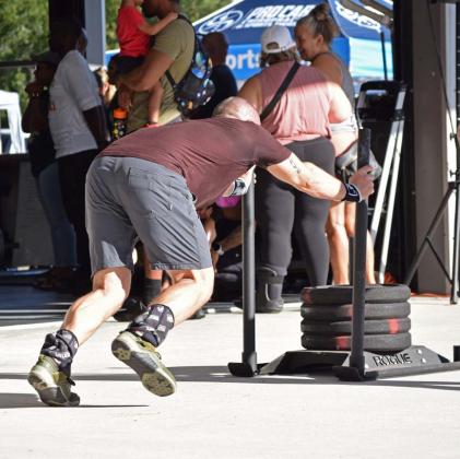 A competitor in a functional fitness competition pushes a sled with a total weight of 187 pounds across a distance in a timed trial. Pushing one’s own limits is the only way to experience significant change, whether that be in fitness, habits and routine, or matters of lifetime accomplishment. alexandria Randolph | dispatch record