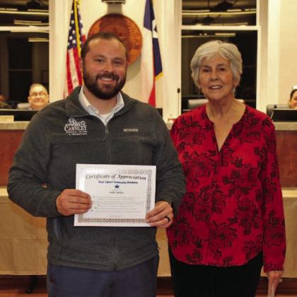 Zach Carnley of Sneed-Carnley Funeral Chapel &amp; Cremations accepts the December Community Champions award from Lampasas Mayor TJ Monroe. COURTESY PHOTO